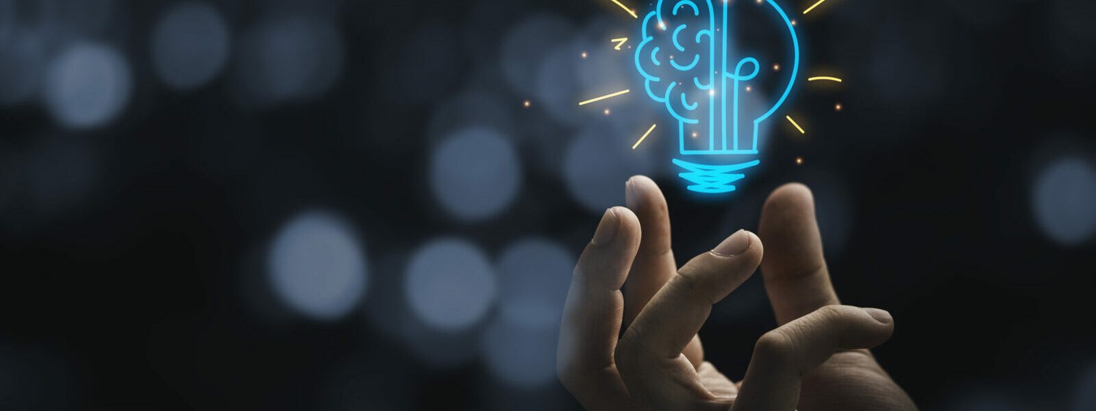 Hand holding drawing virtual lightbulb with brain on bokeh background for creative and smart thinking idea concep Hand holding drawing virtual lightbulb with brain on bokeh background for creative and smart thinking idea concep