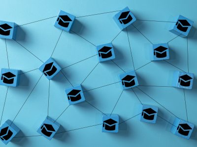 E-learning and online education concept. A network of interconnected blocks with graduation cap icons, symbolizing distance learning, virtual universities, and digital knowledge sharing platforms.